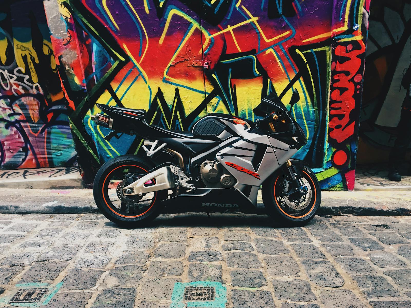 Gray Honda Cbr Parked on the Street near a Street Art